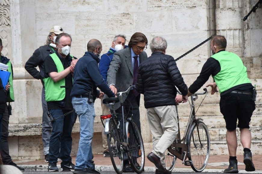 Adam Driver rides a bicycle on the set of The House of Gucci on April 15, 2021 in Rome