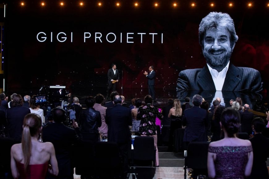 Enrico Brignano and Carlo Conti celebrates Gigi Proietti at the 66th David Di Donatello 2021 prize ceremony on May 11, 2021 in Rome