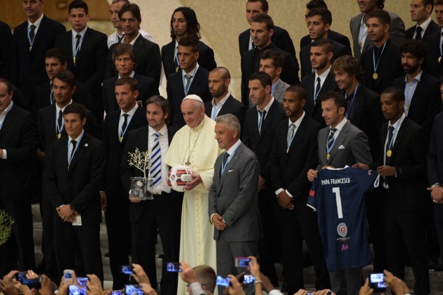 Pope Francis takes a family photo with the players of the 'Partita Interreligiosa Della Pace' at Paul VI Hall on September 1, 2014 in Vatican City
